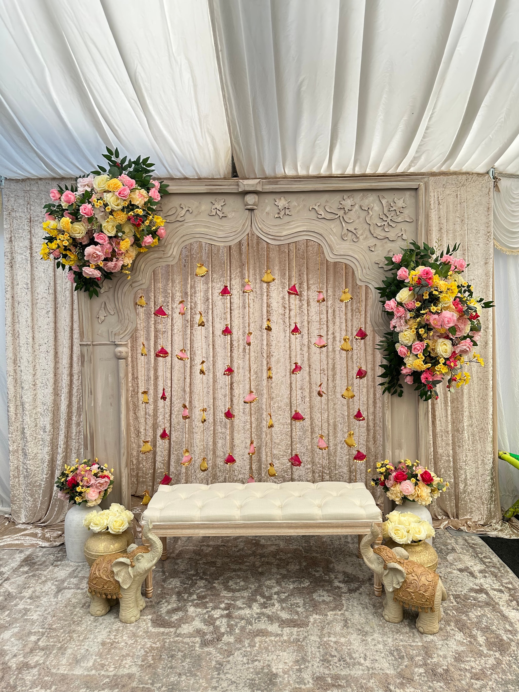 Bespoke Mehndi & Sangeet decor with blush and gold floral backdrop by Sajaavat Events, Birmingham